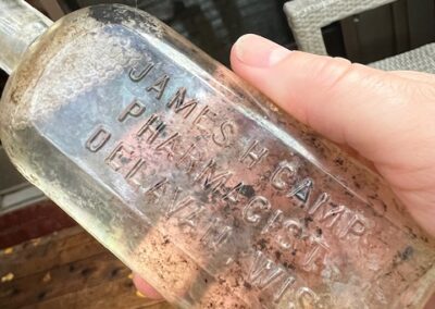 antique bottle dirty with lettering